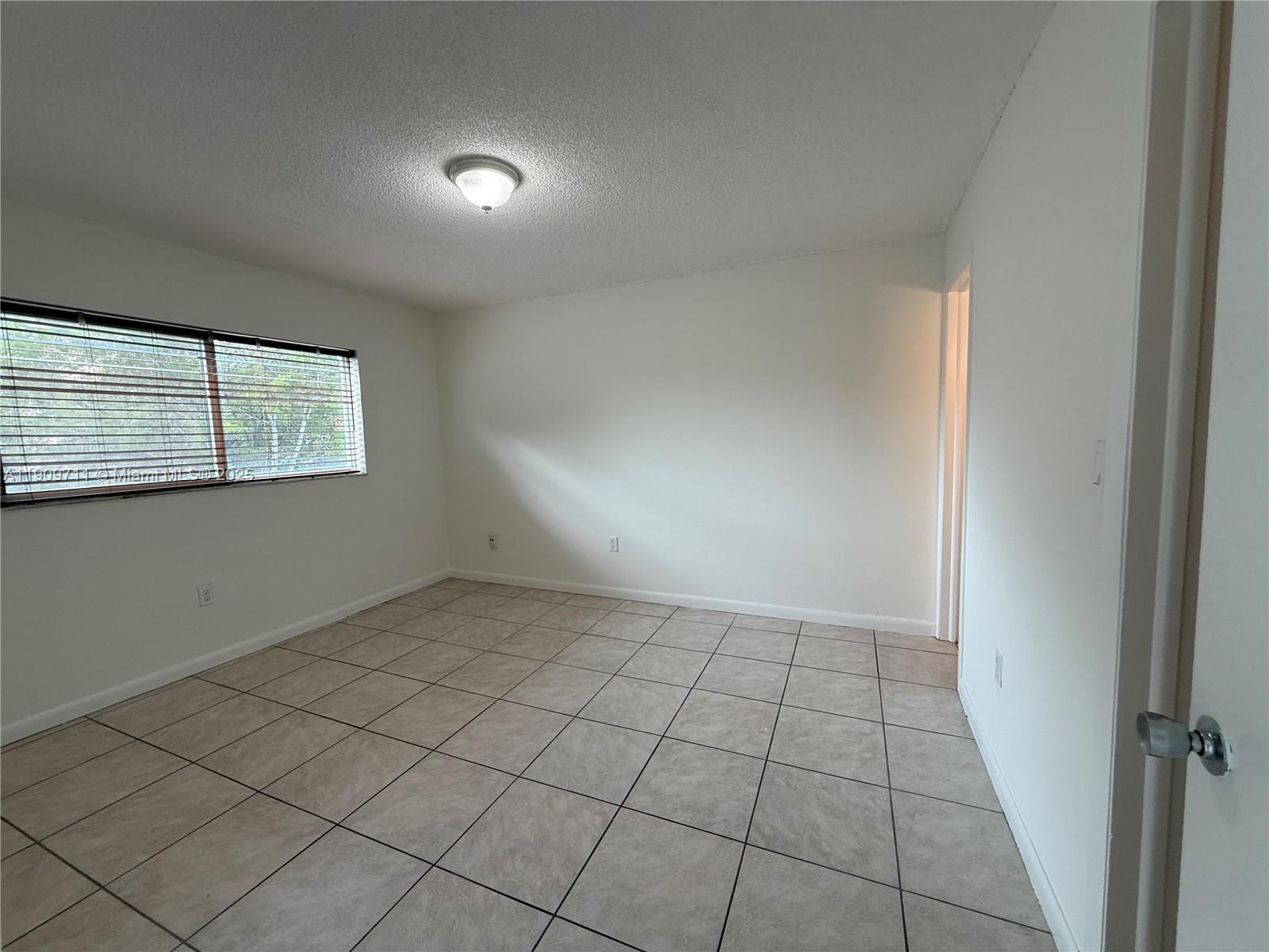 2920 Southwest 28th Terrace, Unit 302 Miami, FL 33133 - Photo 7 of 14 an empty room with windows