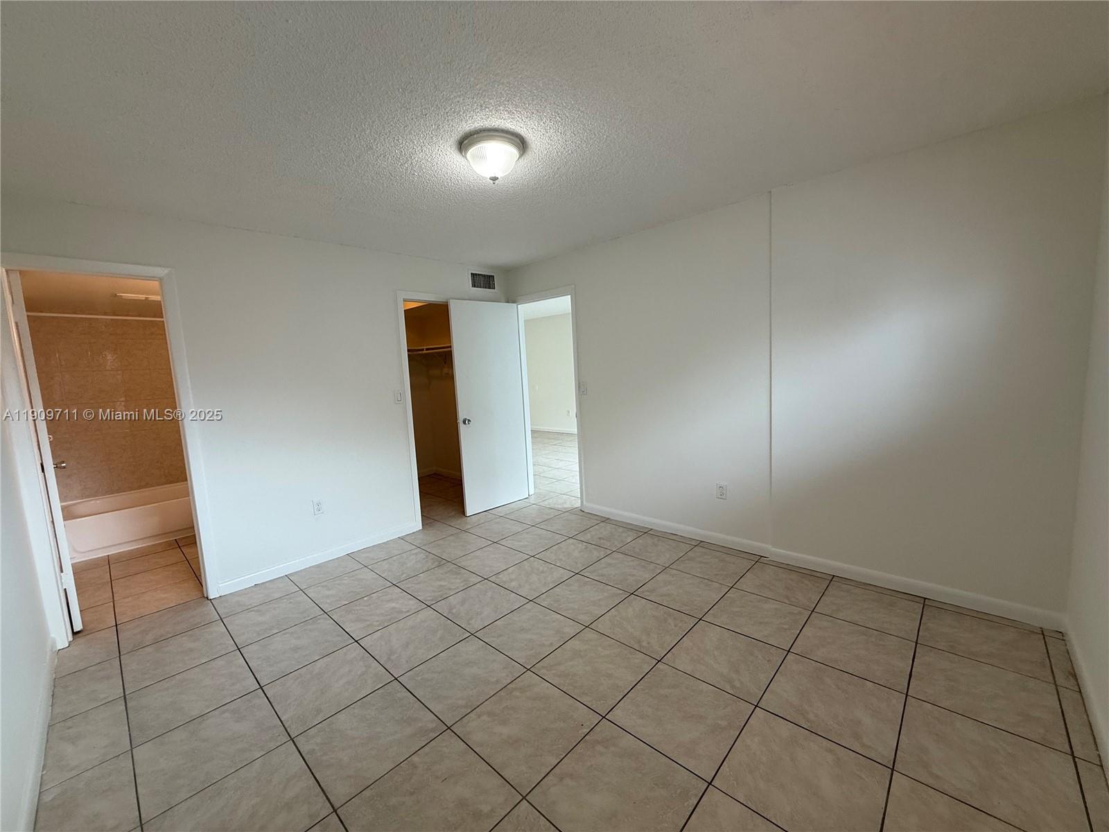 2920 Southwest 28th Terrace, Unit 302 Miami, FL 33133 - Photo 8 of 14 a view of an empty room and wooden floor
