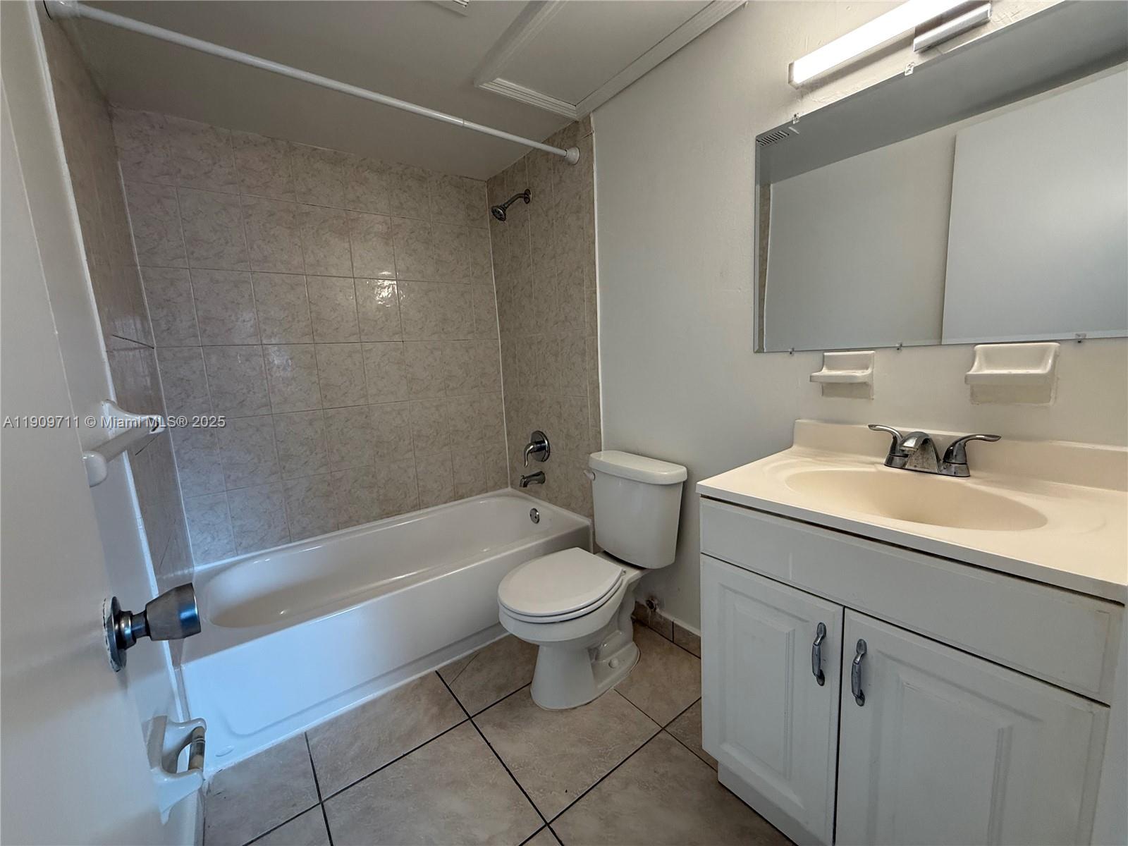 2920 Southwest 28th Terrace, Unit 302 Miami, FL 33133 - Photo 10 of 14 a bathroom with a sink a toilet and shower