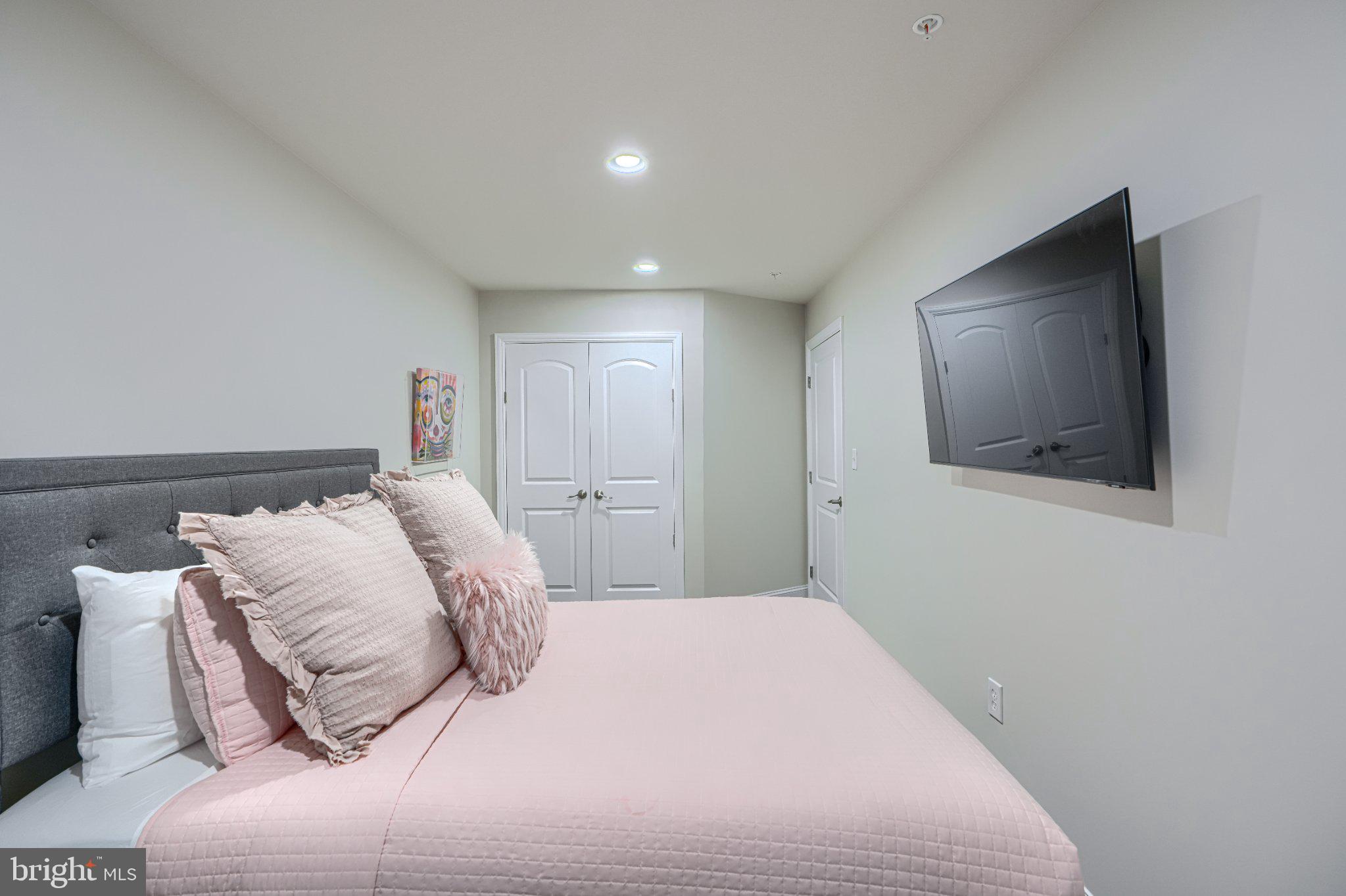 2707 Lady Slipper Road Gambrills, MD 21054 - Photo 54 of 60 a bedroom with a bed and a flat screen tv