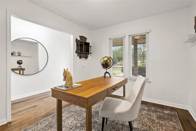 a spacious bedroom with a bed and a chandelier