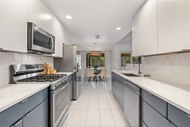 a dining room with furniture potted plants and wooden floor