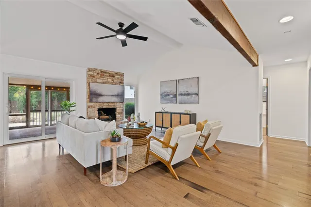 a view of a hallway with wooden floor and glass door
