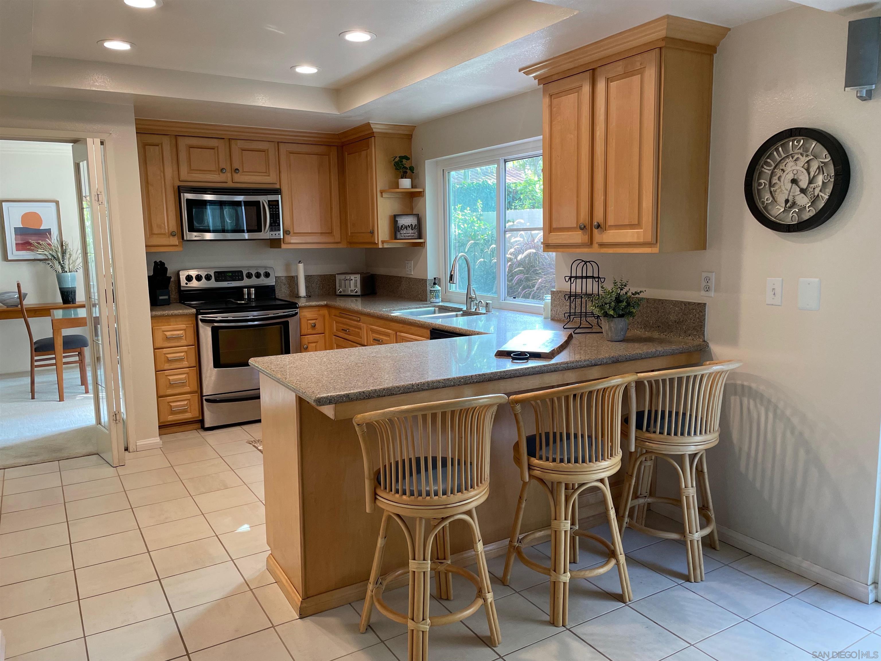 a view of a kitchen with granite countertop a table and chairs