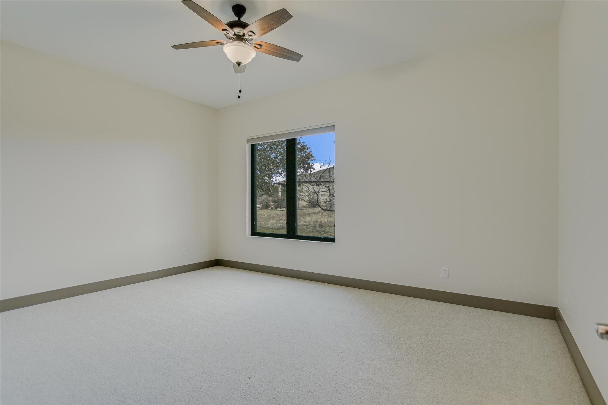 401 Eagle Ridge Burnet, TX 78611 - Photo 18 of 30 an empty room with windows and fan