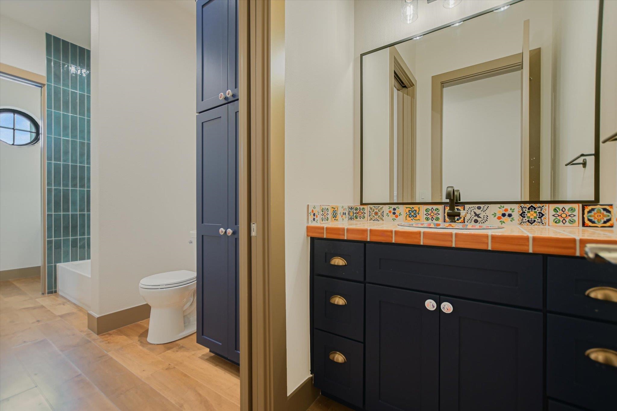 401 Eagle Ridge Burnet, TX 78611 - Photo 21 of 30 a bathroom with a double vanity sink a toilet and a mirror