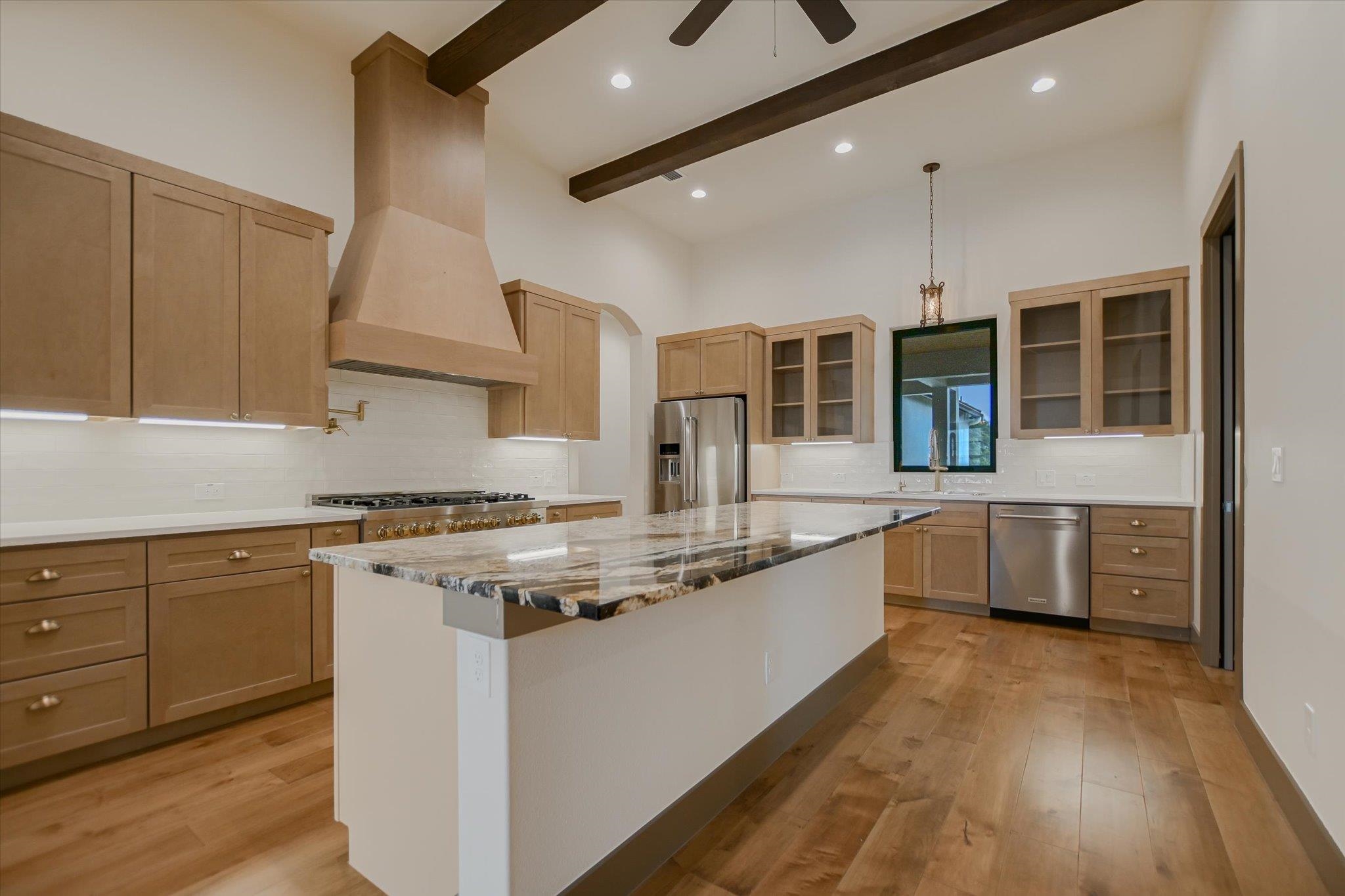 401 Eagle Ridge Burnet, TX 78611 - Photo 5 of 30 a large kitchen with stainless steel appliances granite countertop a stove and a sink