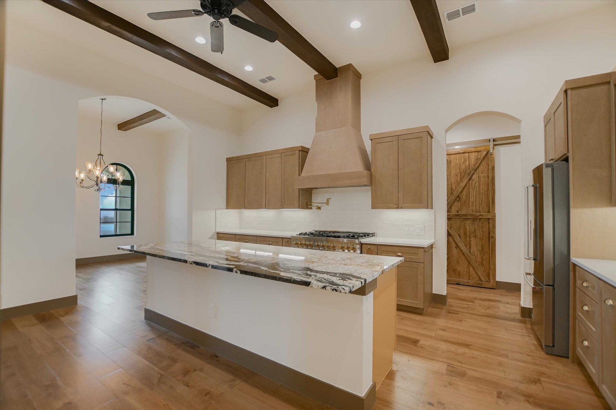 401 Eagle Ridge Burnet, TX 78611 - Photo 6 of 30 a kitchen with stainless steel appliances granite countertop a refrigerator a stove and a sink