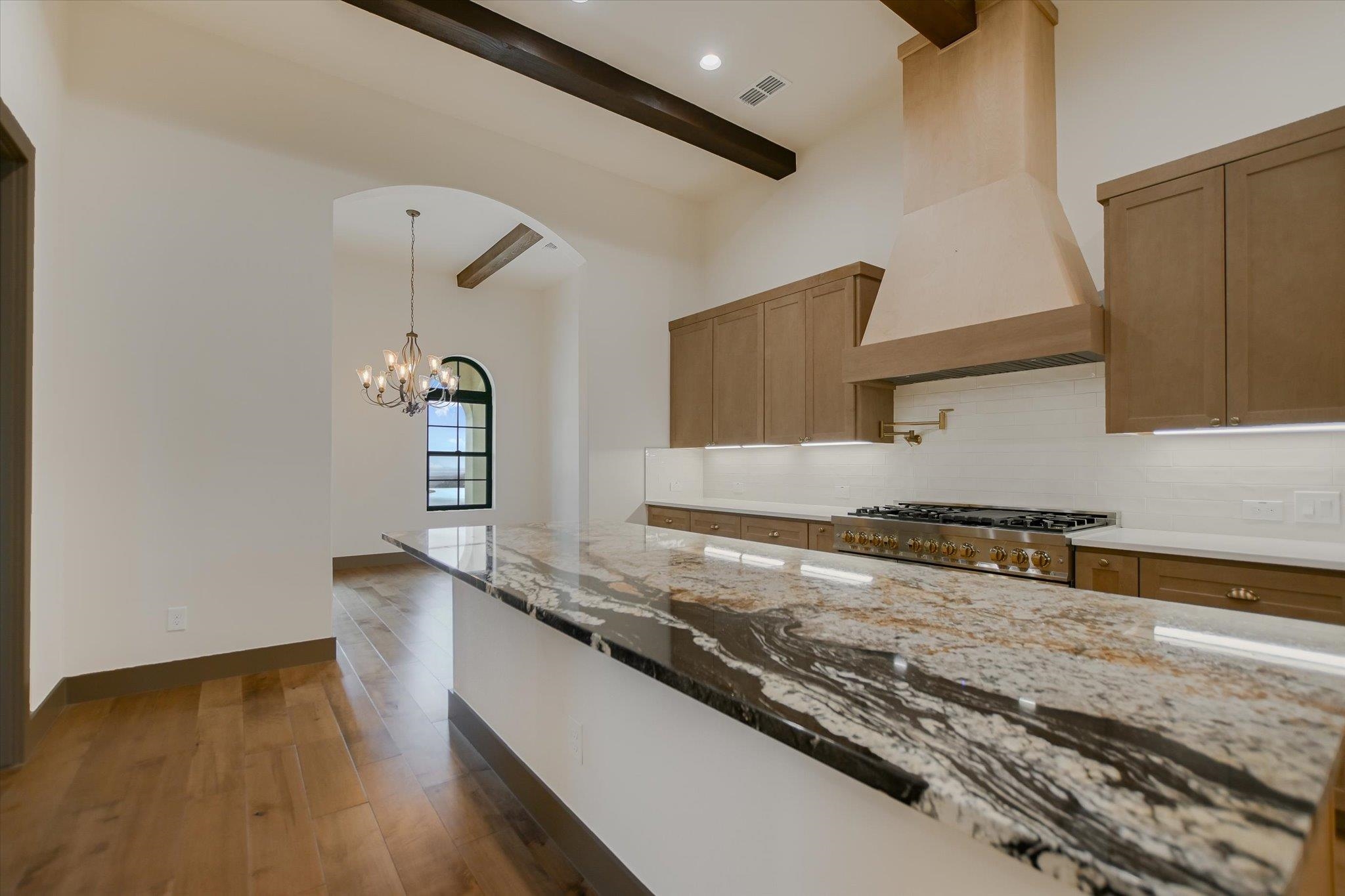 401 Eagle Ridge Burnet, TX 78611 - Photo 8 of 30 a kitchen with granite countertop a sink a stove and cabinets