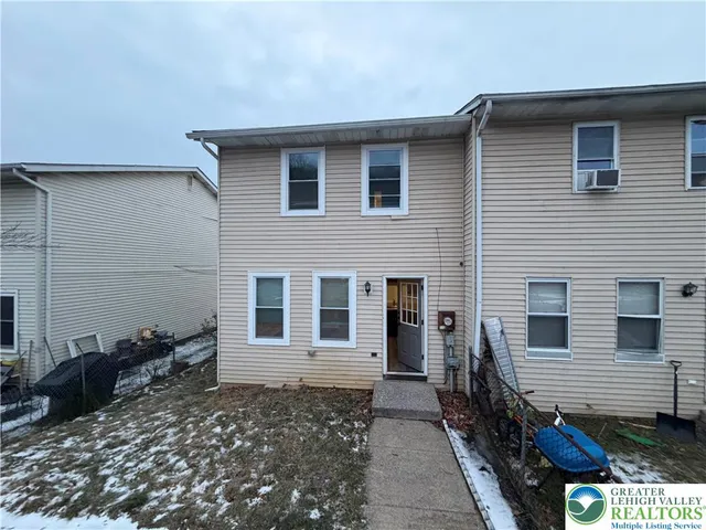 a view of a house with a yard and sitting area