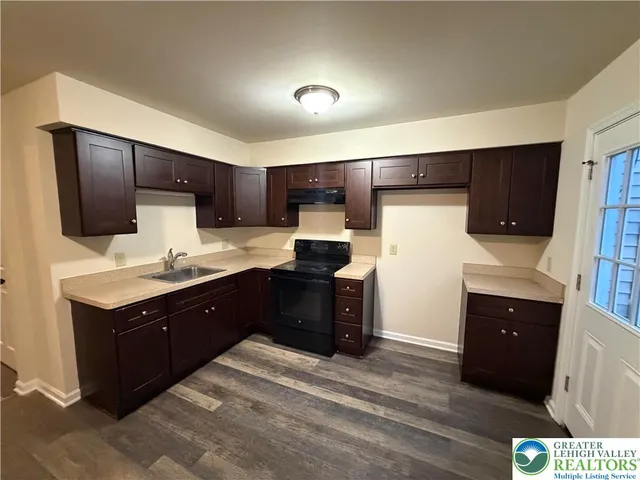 a kitchen with a refrigerator and a sink