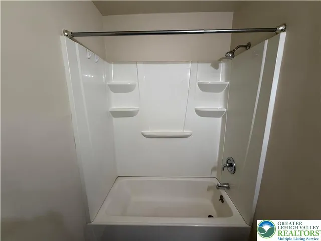 a bathroom with a shower and a bath tub