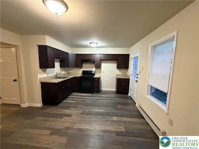 a view of kitchen and kitchen with a sink