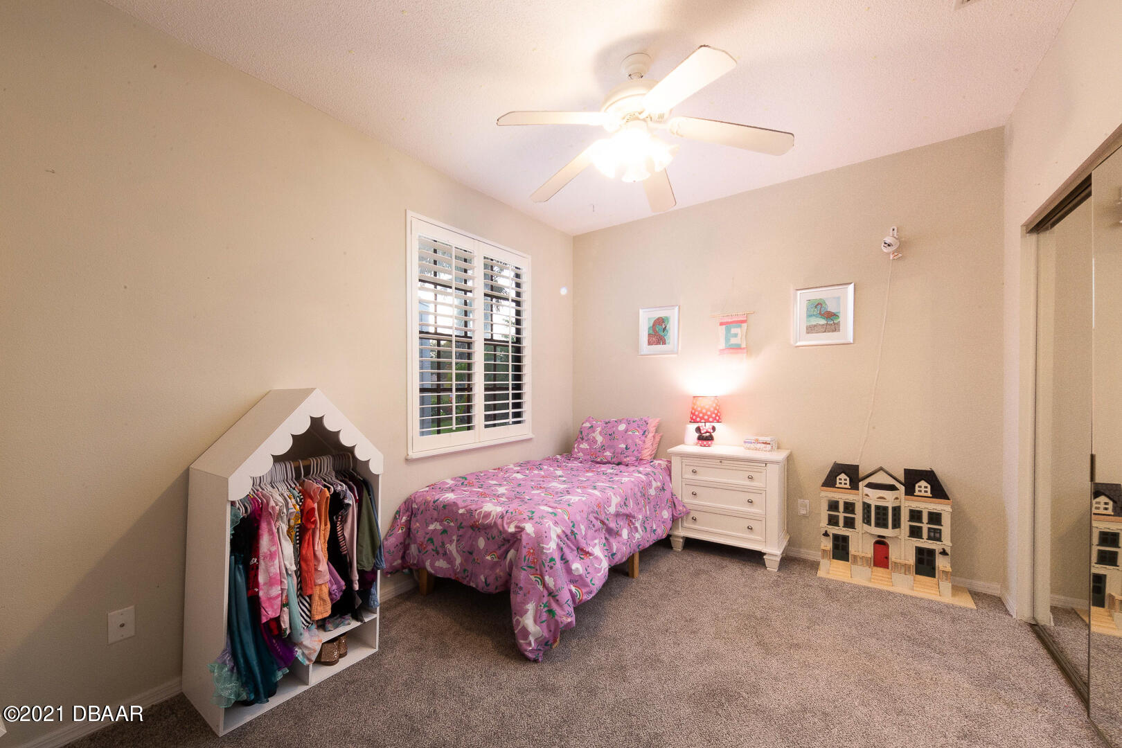 6166 Del Rio Drive Port Orange, FL 32127 - Photo 18 of 53 a bedroom with a bed and a chandelier