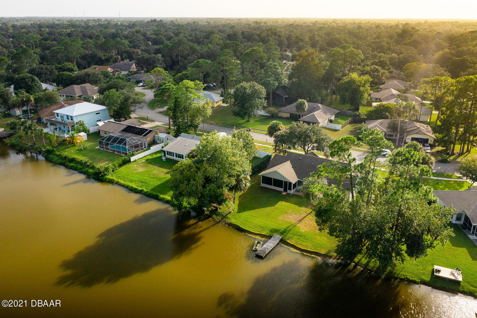 6166 Del Rio Drive Port Orange, FL 32127 - Photo 31 of 53 a view of a lake with a houses