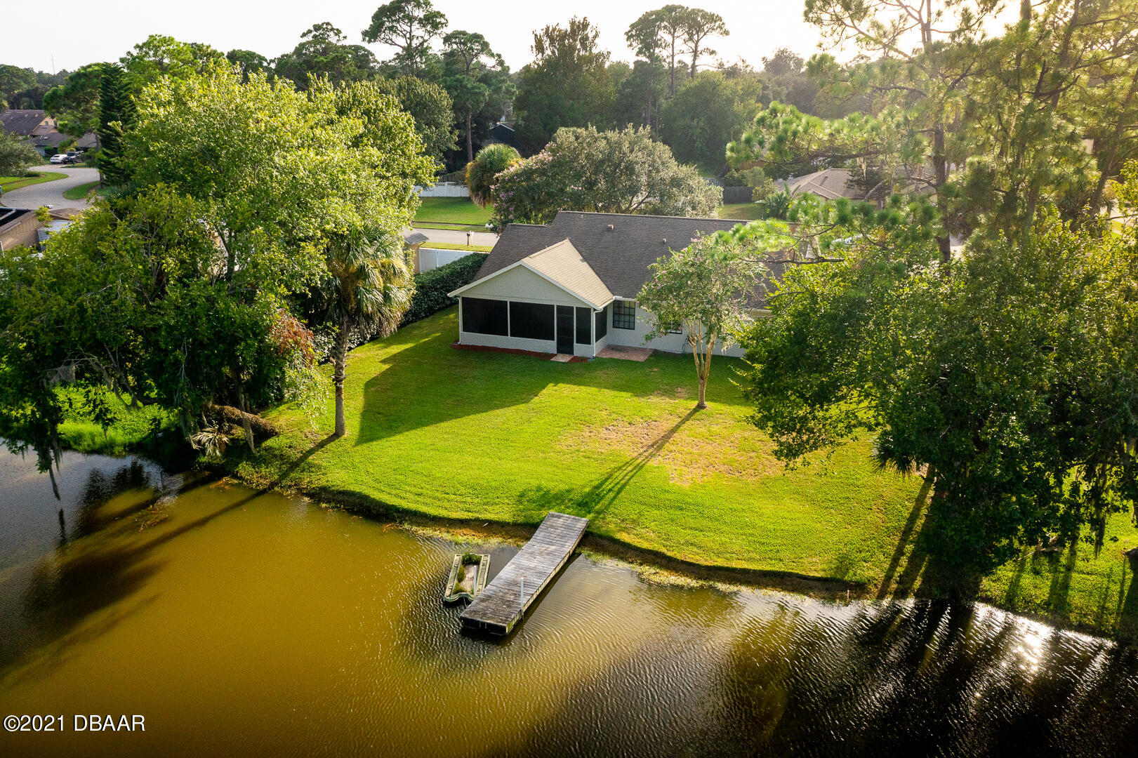 6166 Del Rio Drive Port Orange, FL 32127 - Photo 32 of 53 a view of a swimming pool with lawn chairs and plants