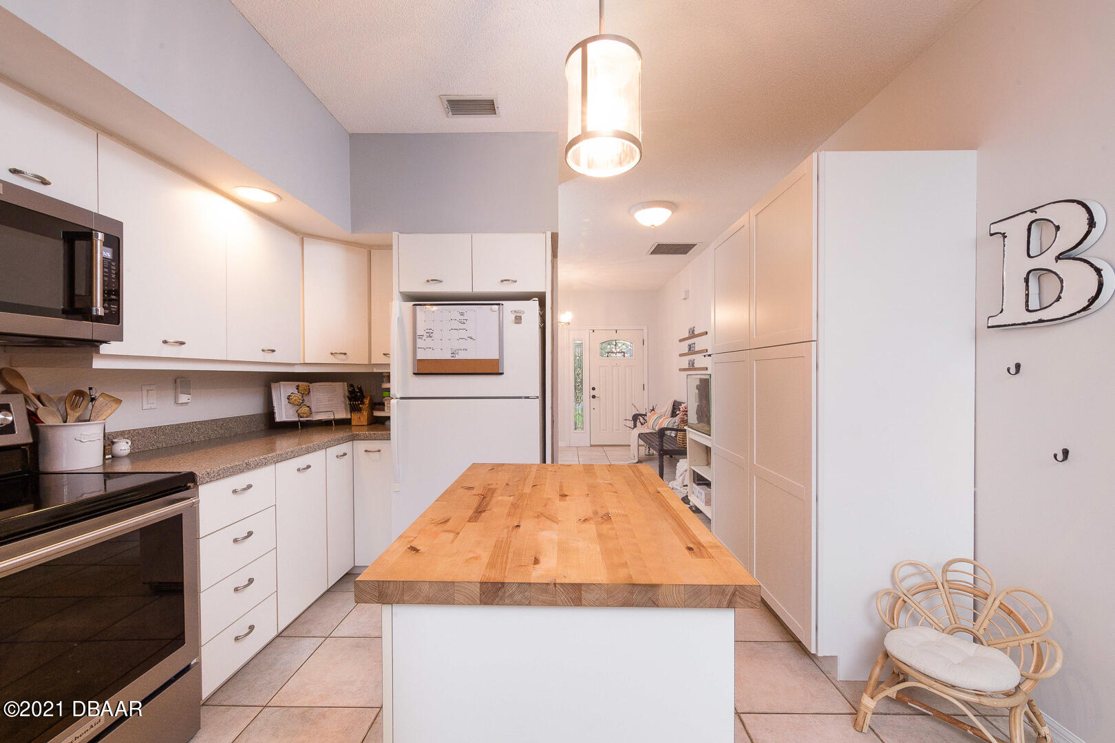 6166 Del Rio Drive Port Orange, FL 32127 - Photo 4 of 53 a large kitchen with kitchen island white cabinets and stainless steel appliances