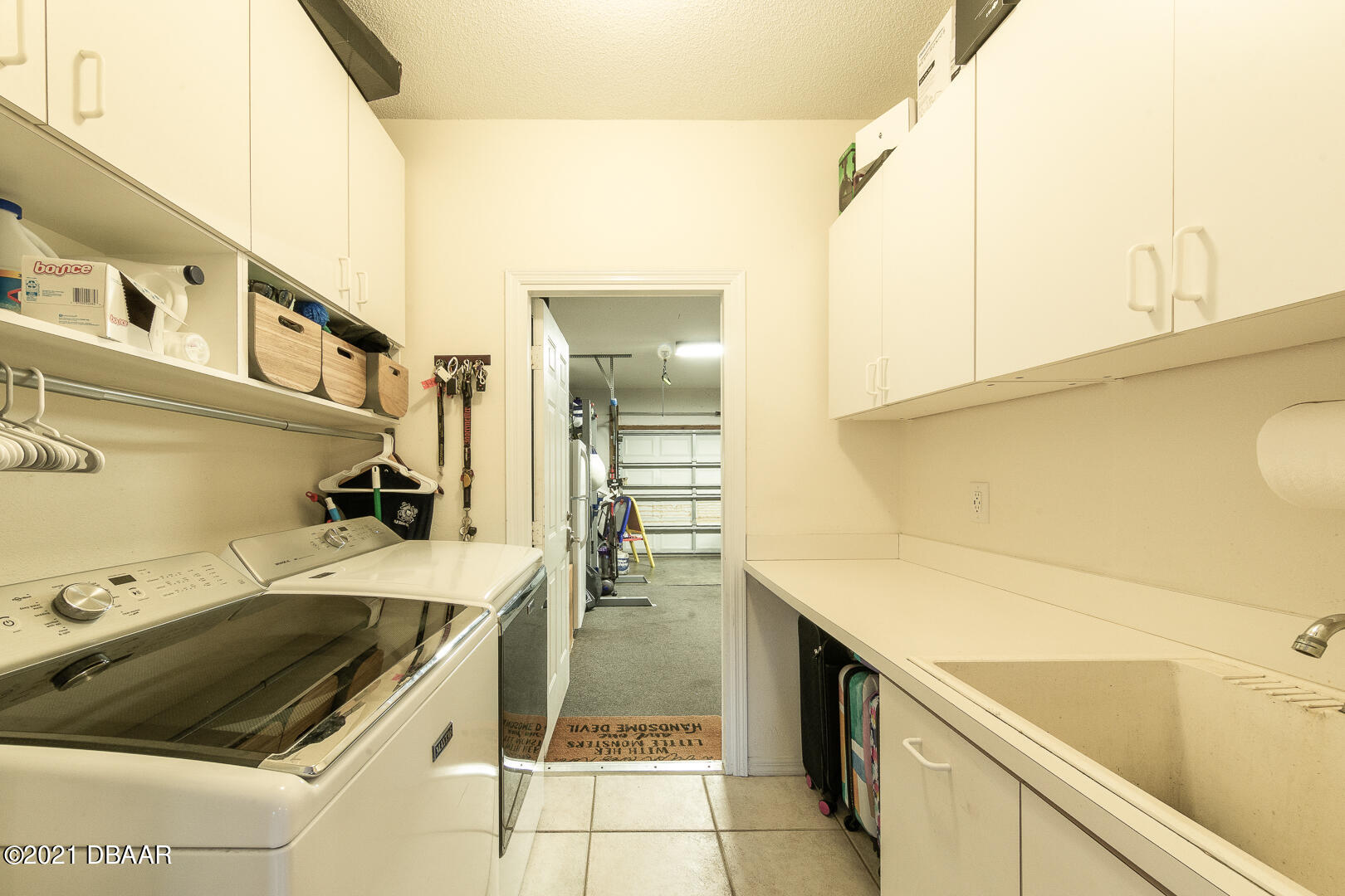 6166 Del Rio Drive Port Orange, FL 32127 - Photo 6 of 53 a utility room with a sink dryer and washer