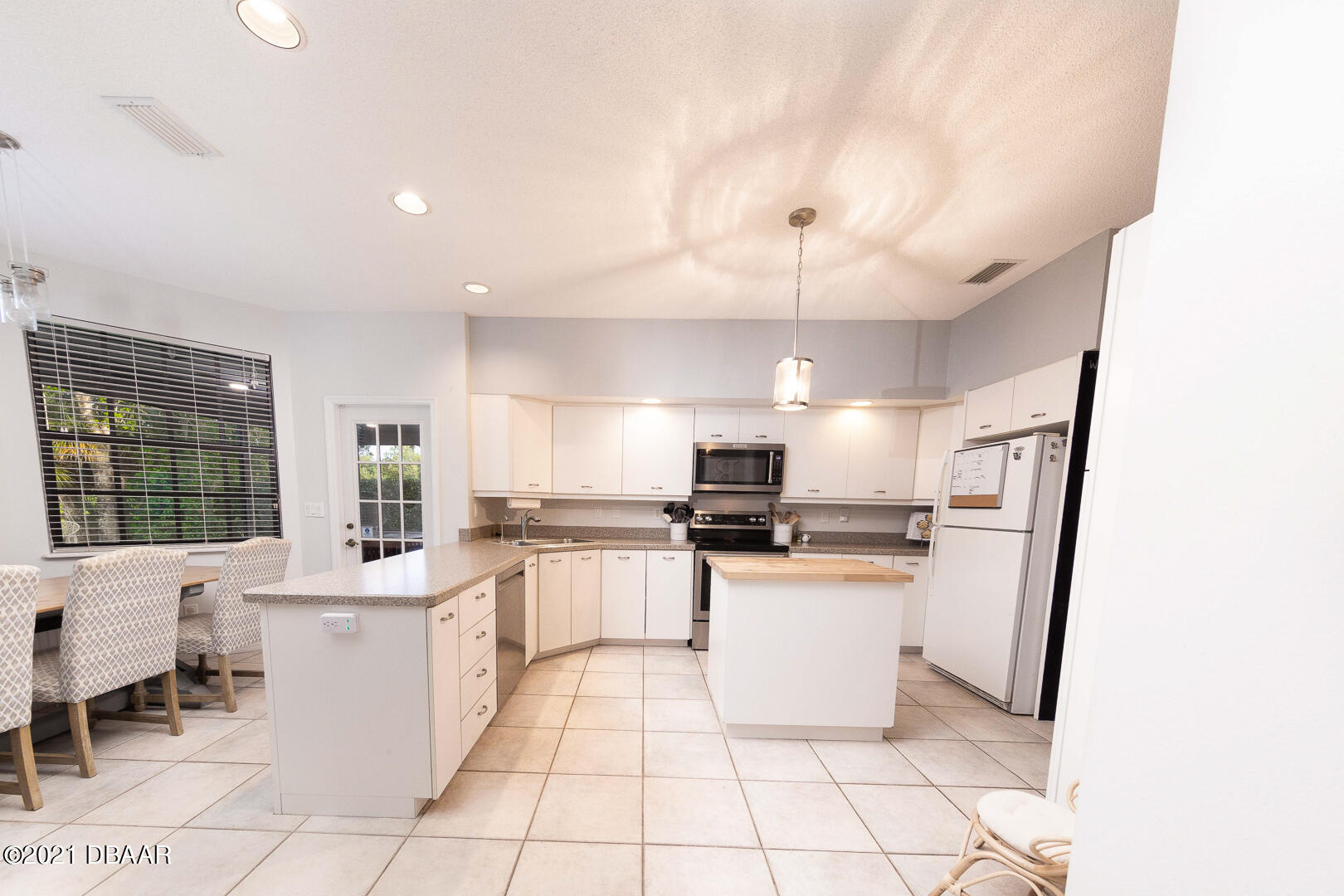 6166 Del Rio Drive Port Orange, FL 32127 - Photo 10 of 53 a kitchen with stainless steel appliances a refrigerator sink and stove