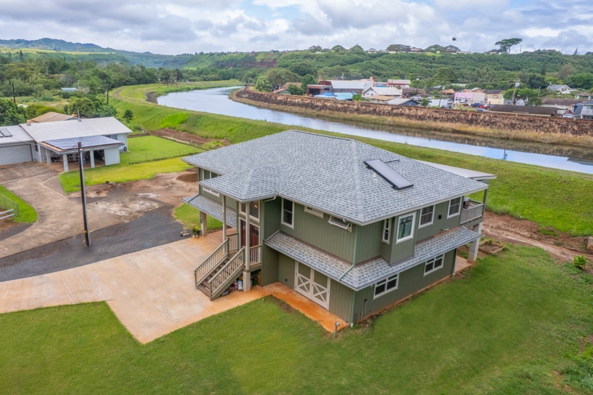 4592 A Awawa Road Hanapepe, HI 96705 - Photo 1 of 24 a aerial view of a house with a garden and lake view