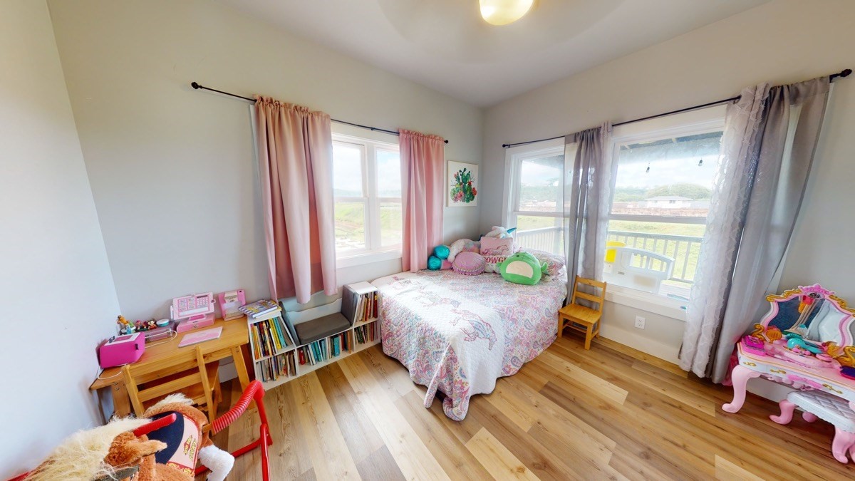 4592 A Awawa Road Hanapepe, HI 96705 - Photo 15 of 24 a bedroom with a bed and a wooden floor
