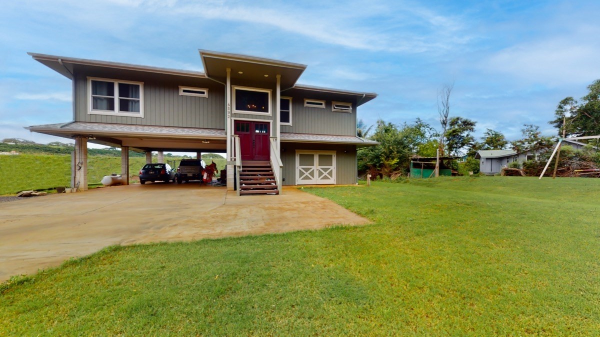 4592 A Awawa Road Hanapepe, HI 96705 - Photo 22 of 24 a view of a brick house with a yard