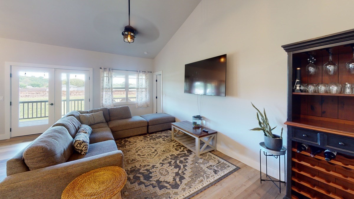4592 A Awawa Road Hanapepe, HI 96705 - Photo 8 of 24 a living room with furniture and a flat screen tv