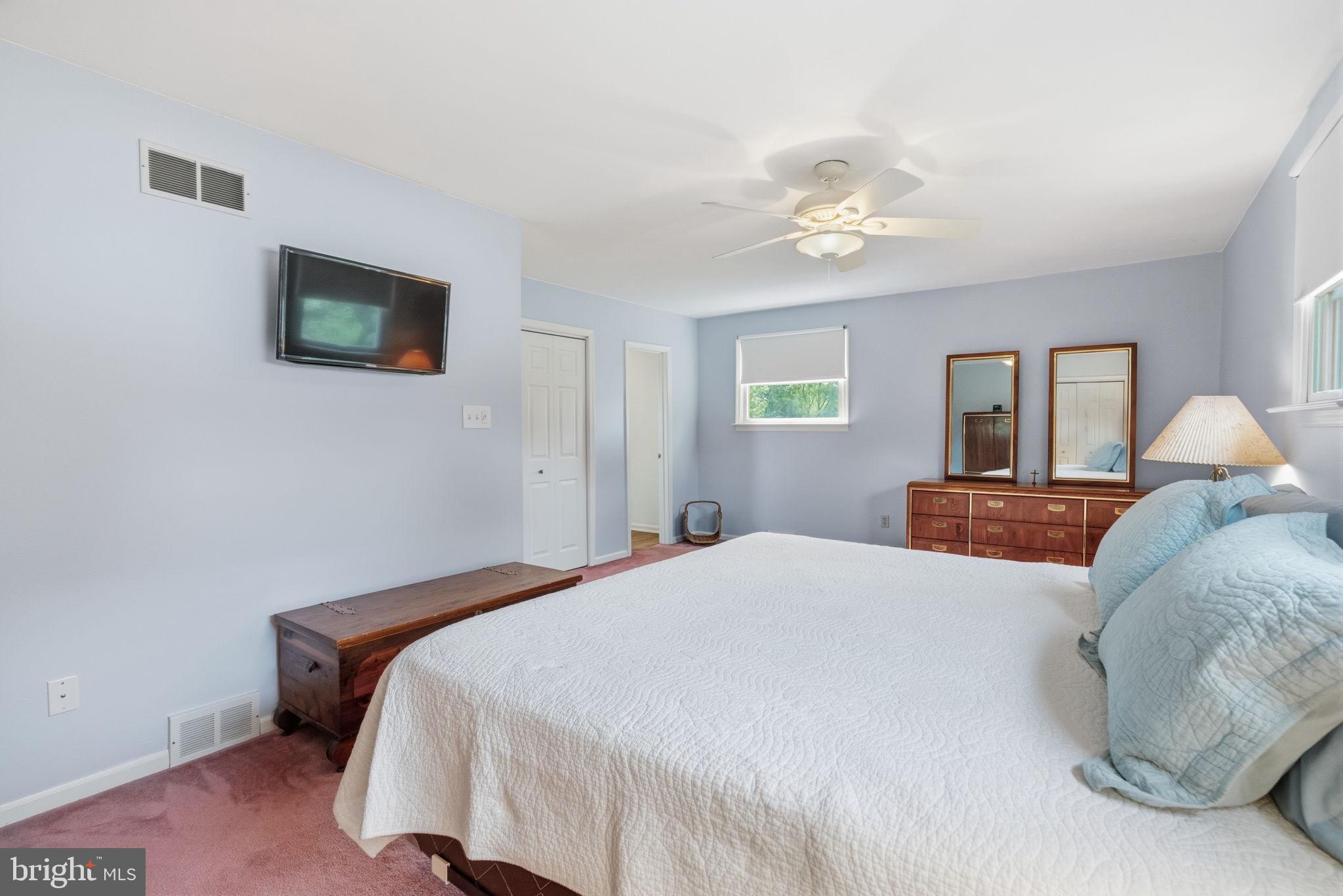 81 Cherokee Road Doylestown, PA 18901 - Photo 19 of 43 a bedroom with a bed and a chandelier