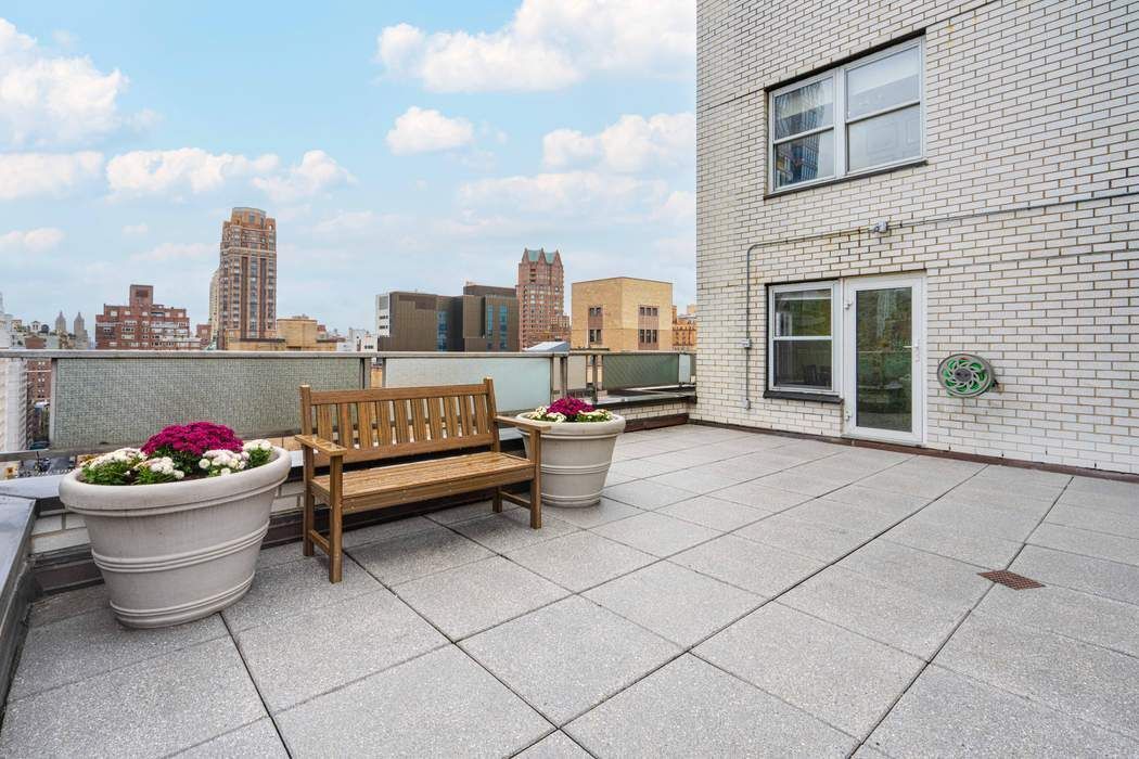 301 East 75th Street, Unit 19B Manhattan, NY 10021 - Photo 10 of 21 a couch on a table and a potted plant