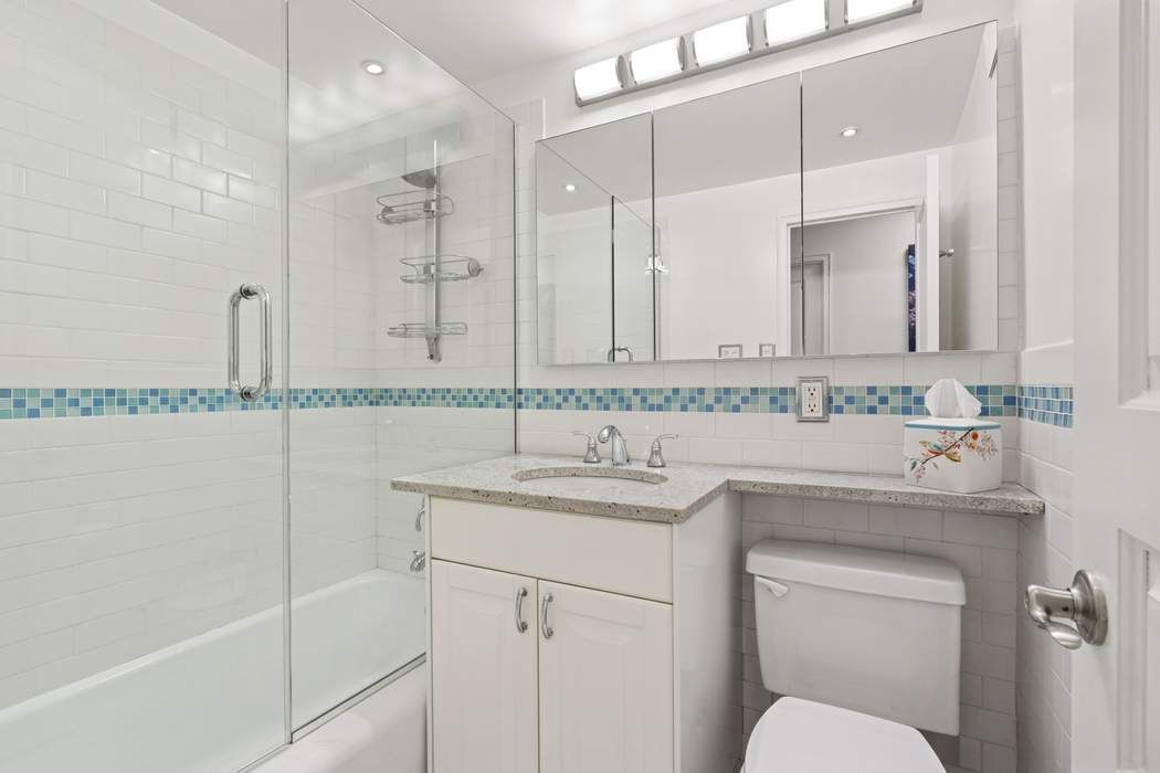 301 East 75th Street, Unit 19B Manhattan, NY 10021 - Photo 13 of 21 a bathroom with a sink and a mirror