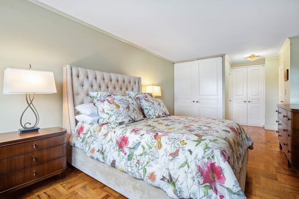 301 East 75th Street, Unit 19B Manhattan, NY 10021 - Photo 15 of 21 a bedroom with a bed and a lamp