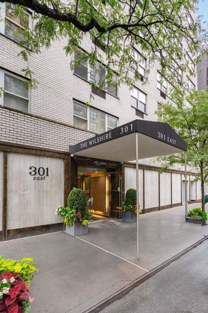 301 East 75th Street, Unit 19B Manhattan, NY 10021 - Photo 20 of 21 a front view of a building with potted plants