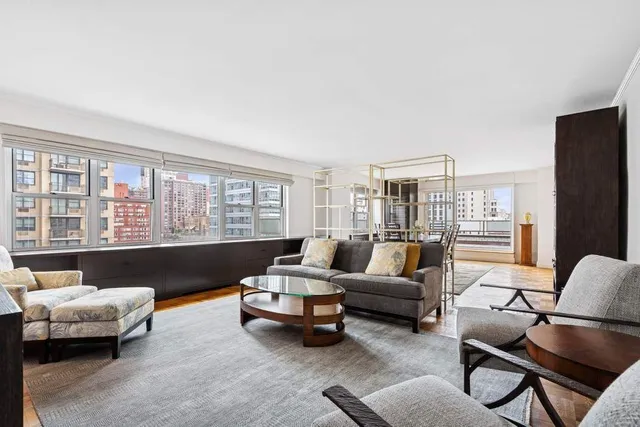 a living room with furniture and large windows
