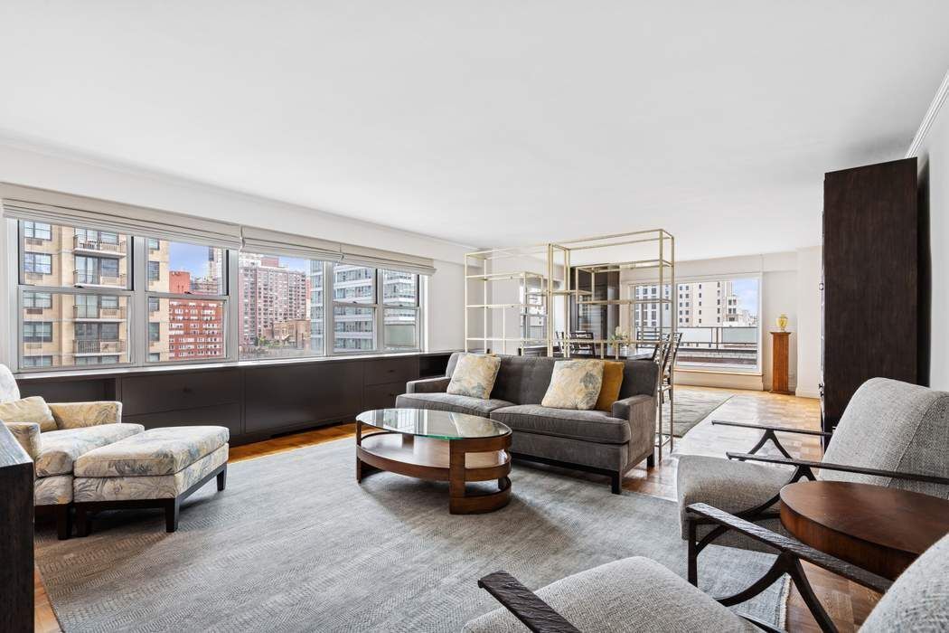 301 East 75th Street, Unit 19B Manhattan, NY 10021 - Photo 3 of 21 a living room with furniture and large windows