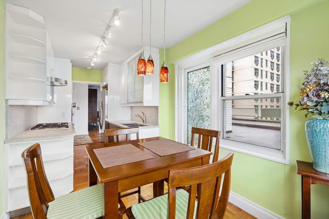 301 East 75th Street, Unit 19B Manhattan, NY 10021 - Photo 6 of 21 a view of a dining room with furniture window and outside view