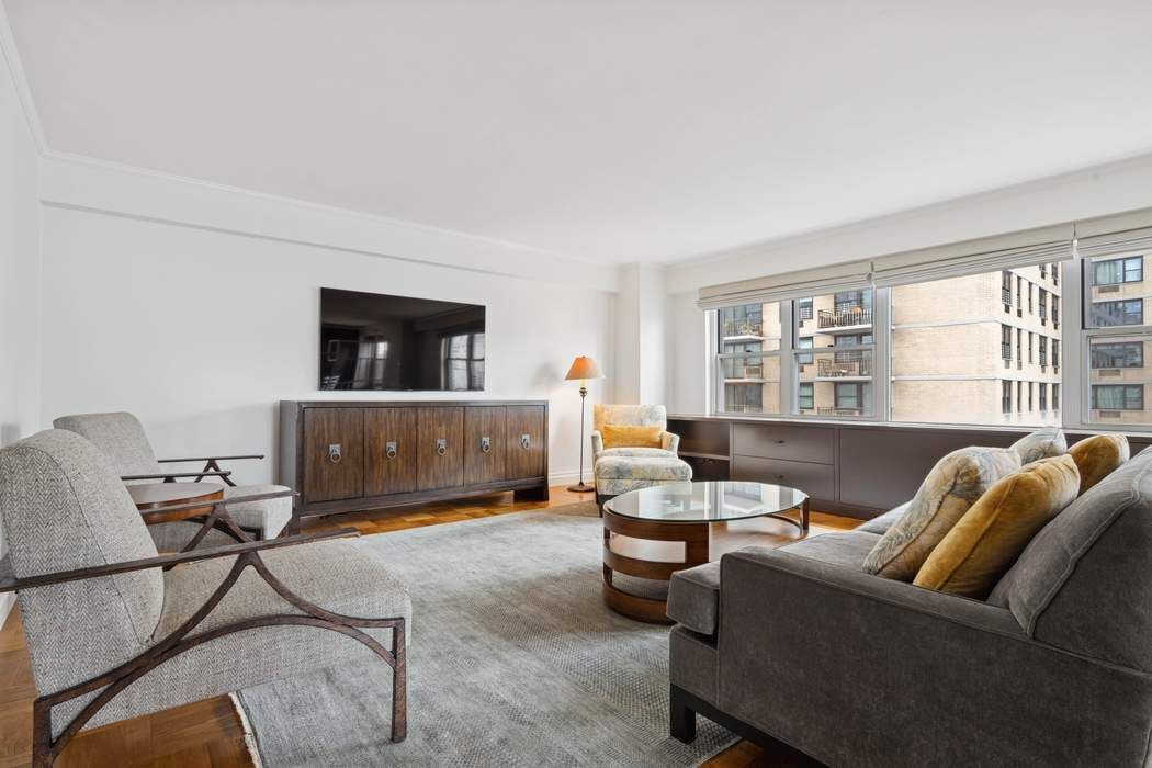 301 East 75th Street, Unit 19B Manhattan, NY 10021 - Photo 8 of 21 a living room with furniture and a floor to ceiling window
