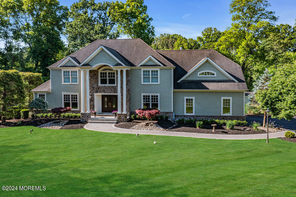 a front view of a house with garden and sitting area