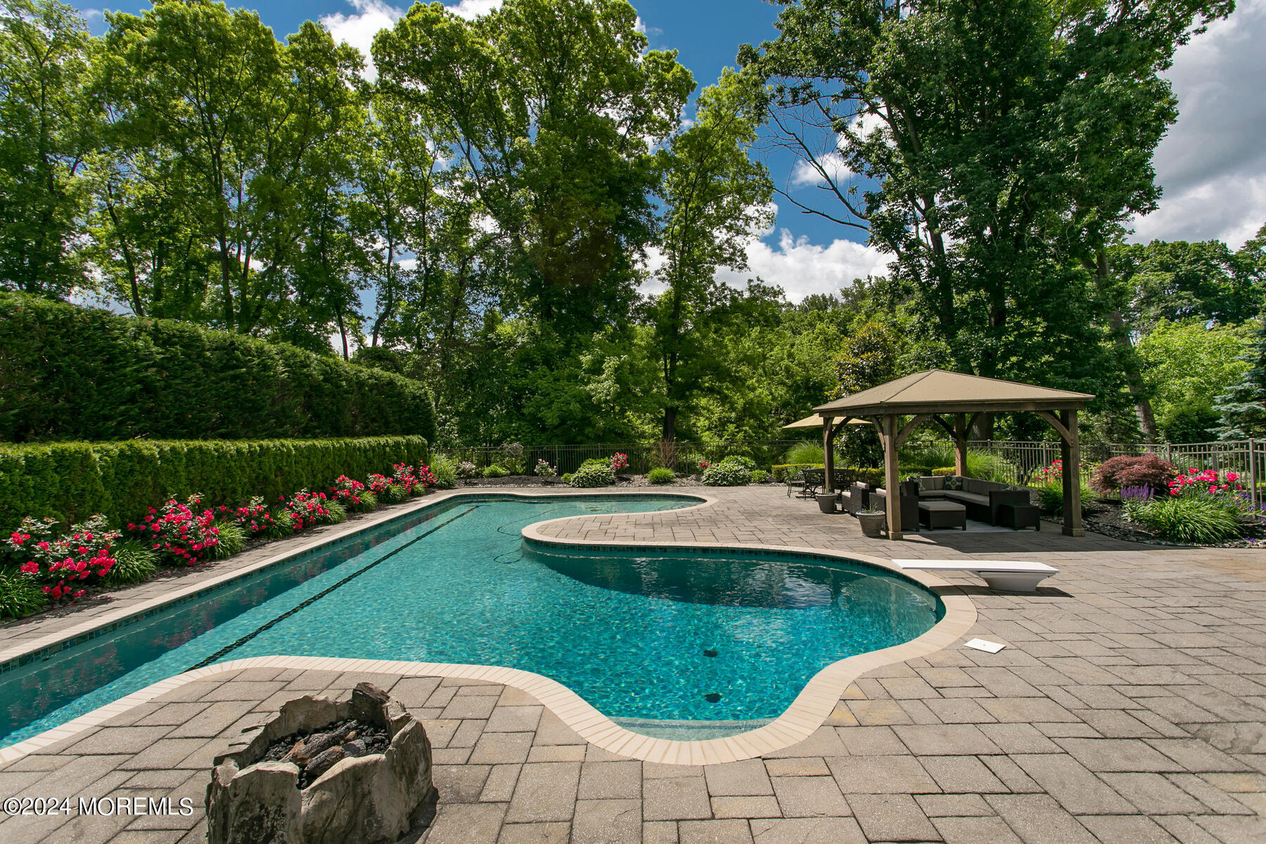 44 Meadowview Drive Colts Neck, NJ 07722 - Photo 47 of 68 a view of a swimming pool and lounge chair