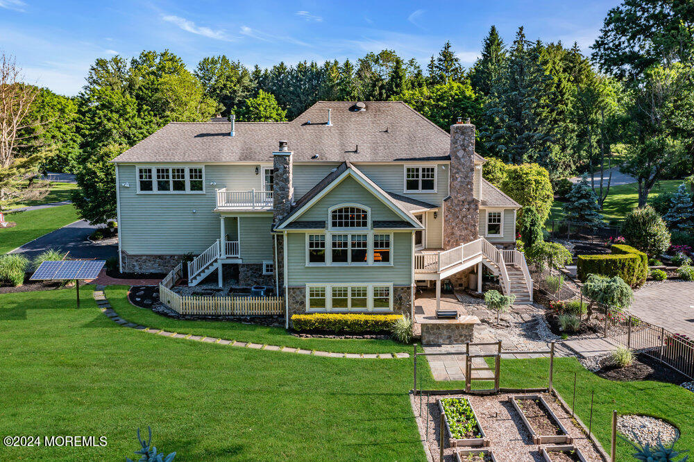 44 Meadowview Drive Colts Neck, NJ 07722 - Photo 5 of 68 a aerial view of a house with a big yard and potted plants