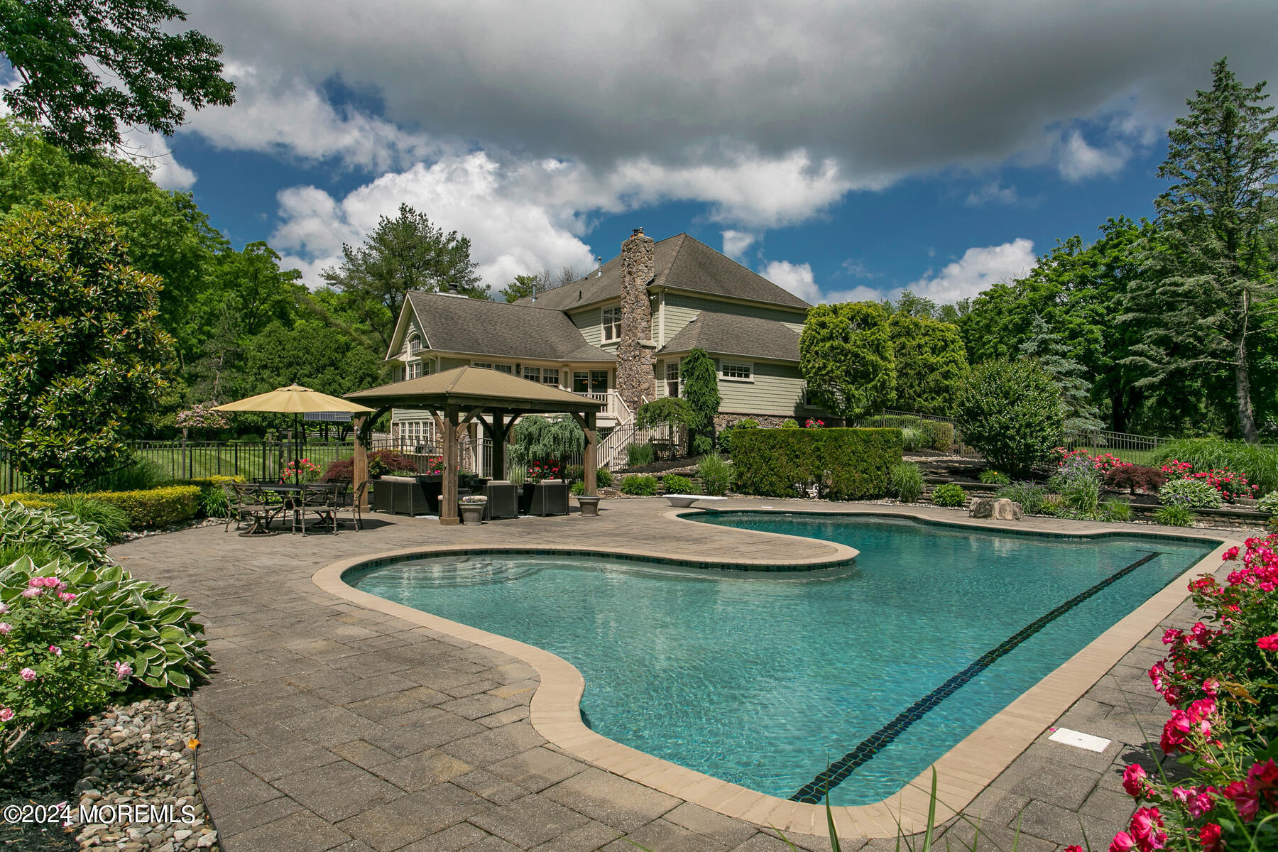 44 Meadowview Drive Colts Neck, NJ 07722 - Photo 52 of 68 a view of a swimming pool and lounge chairs