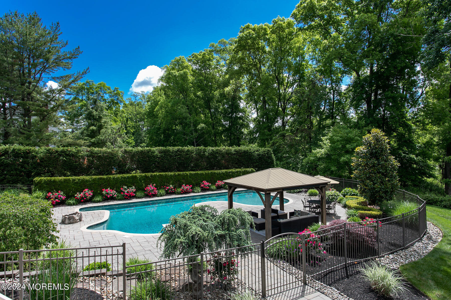 44 Meadowview Drive Colts Neck, NJ 07722 - Photo 55 of 68 a view of a table and chairs under an umbrella