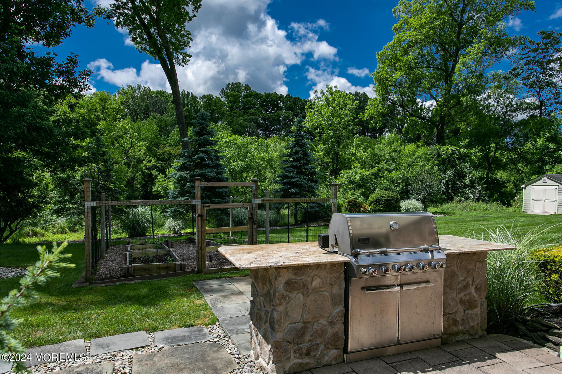 44 Meadowview Drive Colts Neck, NJ 07722 - Photo 56 of 68 a view of a chair and fire pit in the backyard