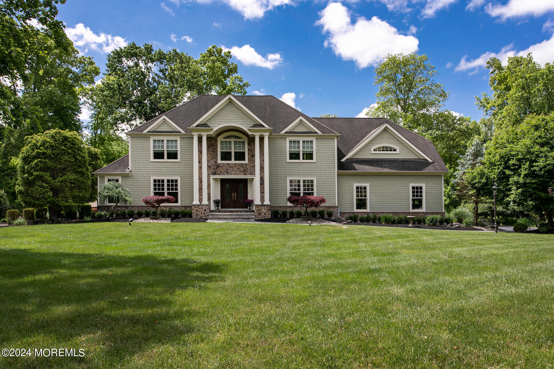 44 Meadowview Drive Colts Neck, NJ 07722 - Photo 60 of 68 a front view of a house with a yard and trees