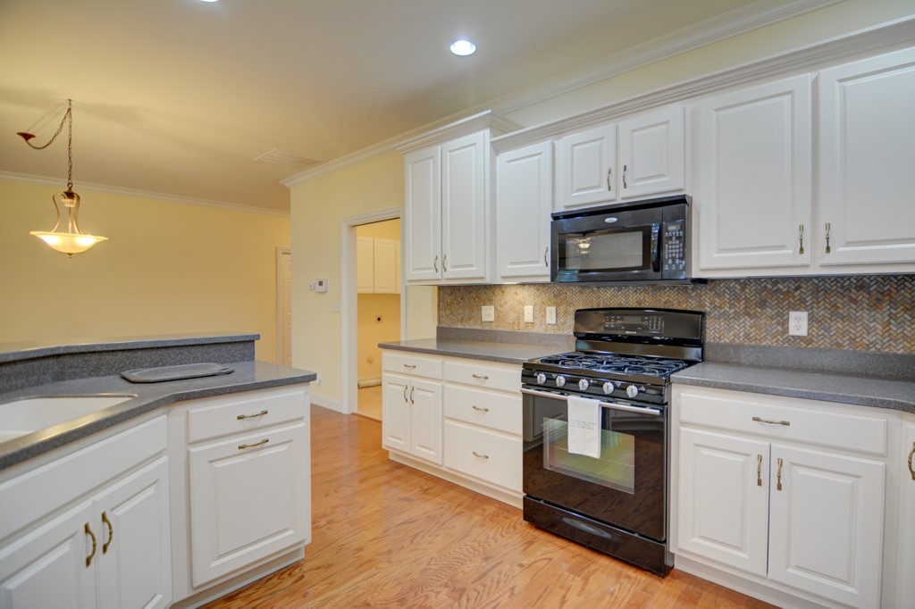 2930 Augusta Avenue Decatur, IL 62521 - Photo 12 of 28 a kitchen with granite countertop white cabinets and appliances