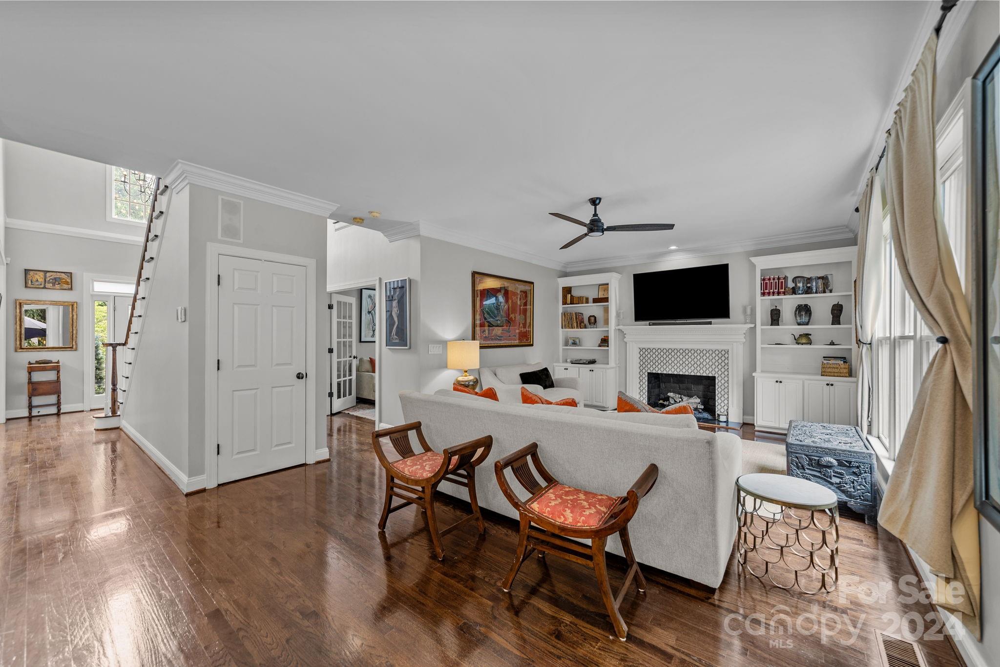 20443 Middletown Road Cornelius, NC 28031 - Photo 11 of 31 a living room with furniture a fireplace and a flat screen tv