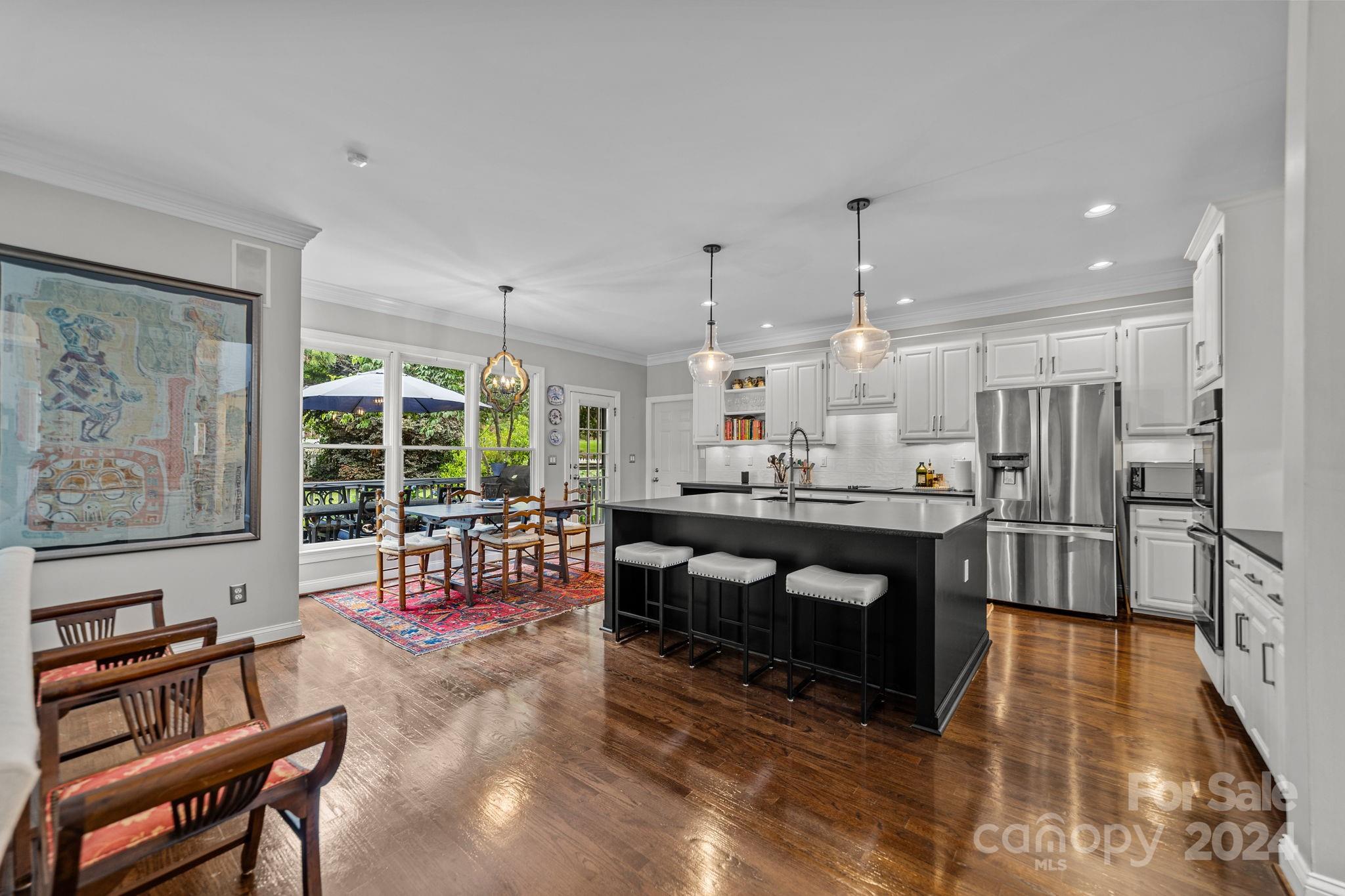 20443 Middletown Road Cornelius, NC 28031 - Photo 12 of 31 a large living room with stainless steel appliances kitchen island granite countertop furniture and a rug