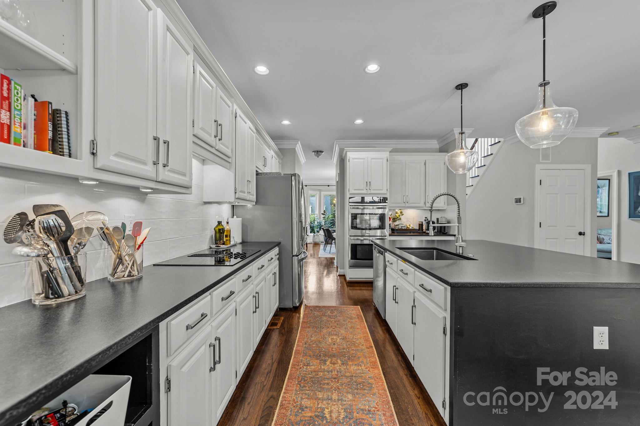 20443 Middletown Road Cornelius, NC 28031 - Photo 14 of 31 a kitchen with granite countertop a sink a stove top oven a counter space and cabinets