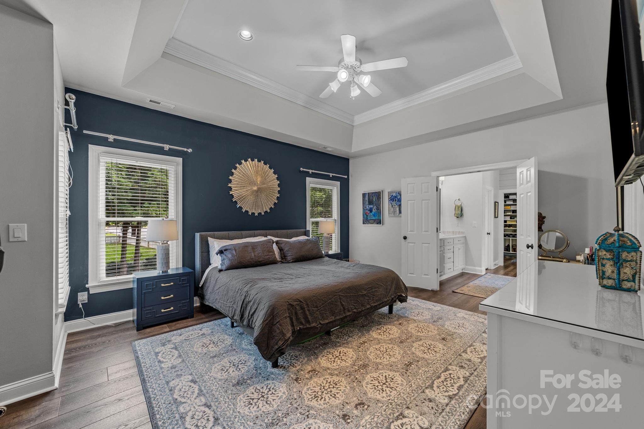 20443 Middletown Road Cornelius, NC 28031 - Photo 20 of 31 a bedroom with a large bed and a chandelier