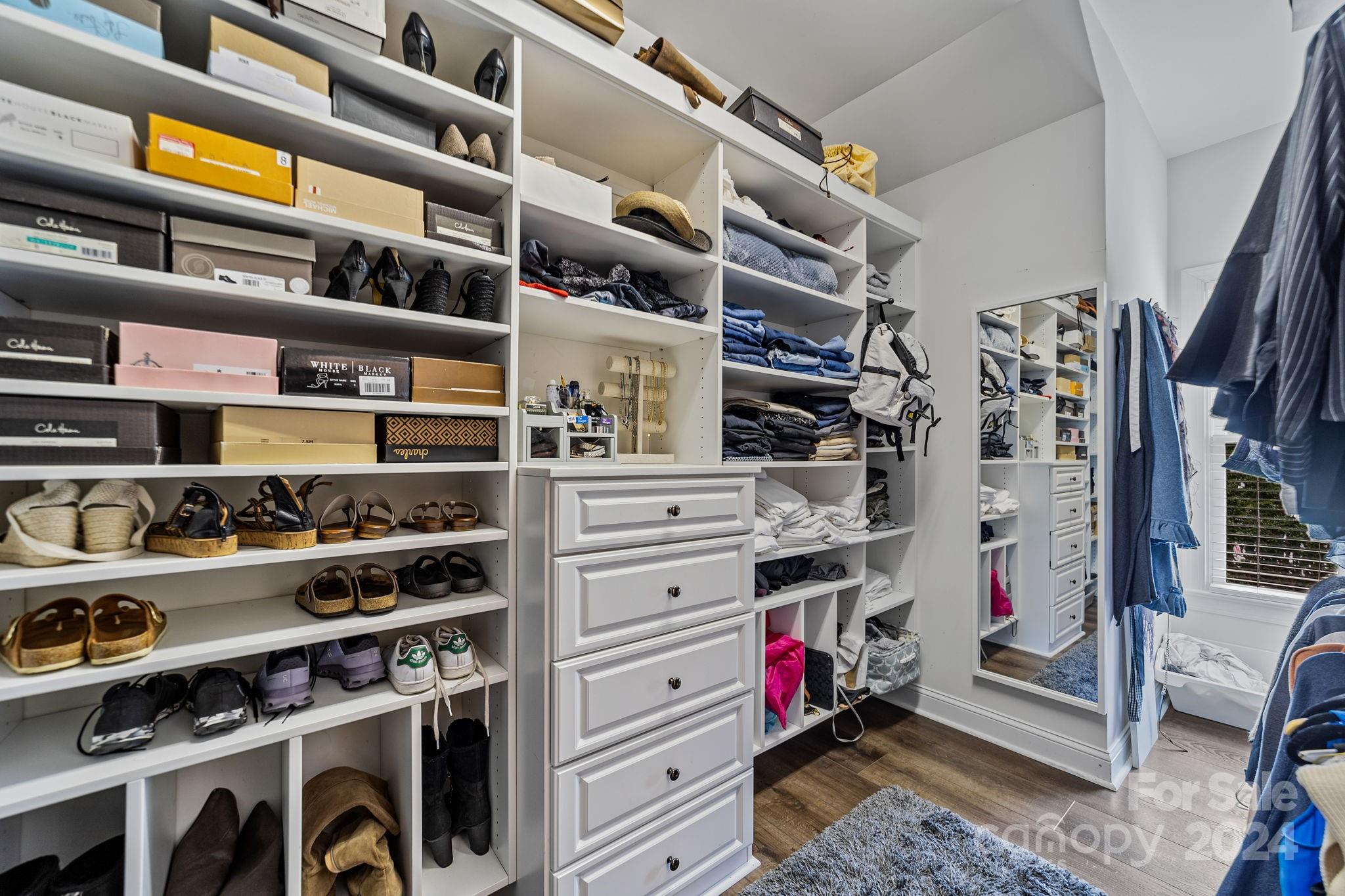 20443 Middletown Road Cornelius, NC 28031 - Photo 24 of 31 a view of walk in closet with clothes and shoes