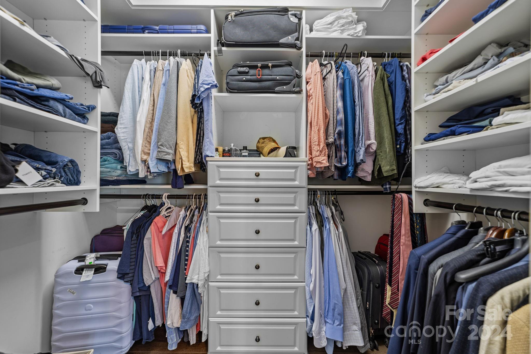 20443 Middletown Road Cornelius, NC 28031 - Photo 25 of 31 a view of walk in closet with clothes and shoes